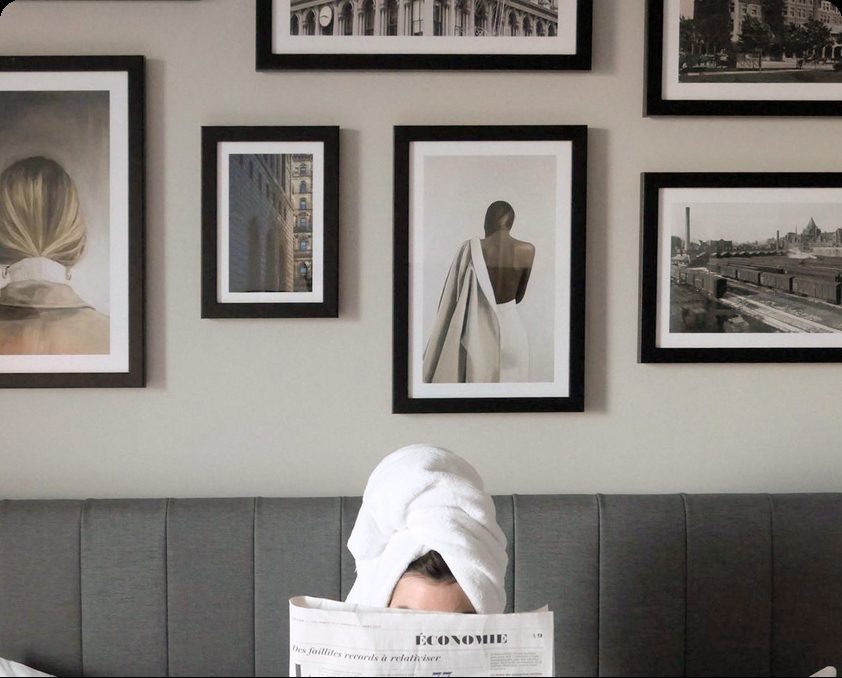 Guest room with a gallery wall of framed artwork above the bed