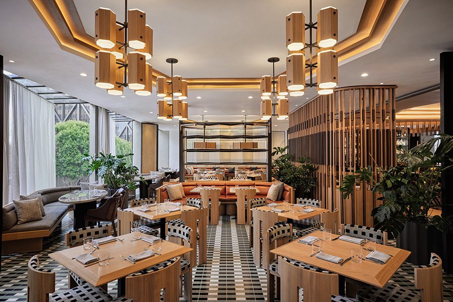 Restaurant dining room with custom chairs, banquettes, and wood pendants