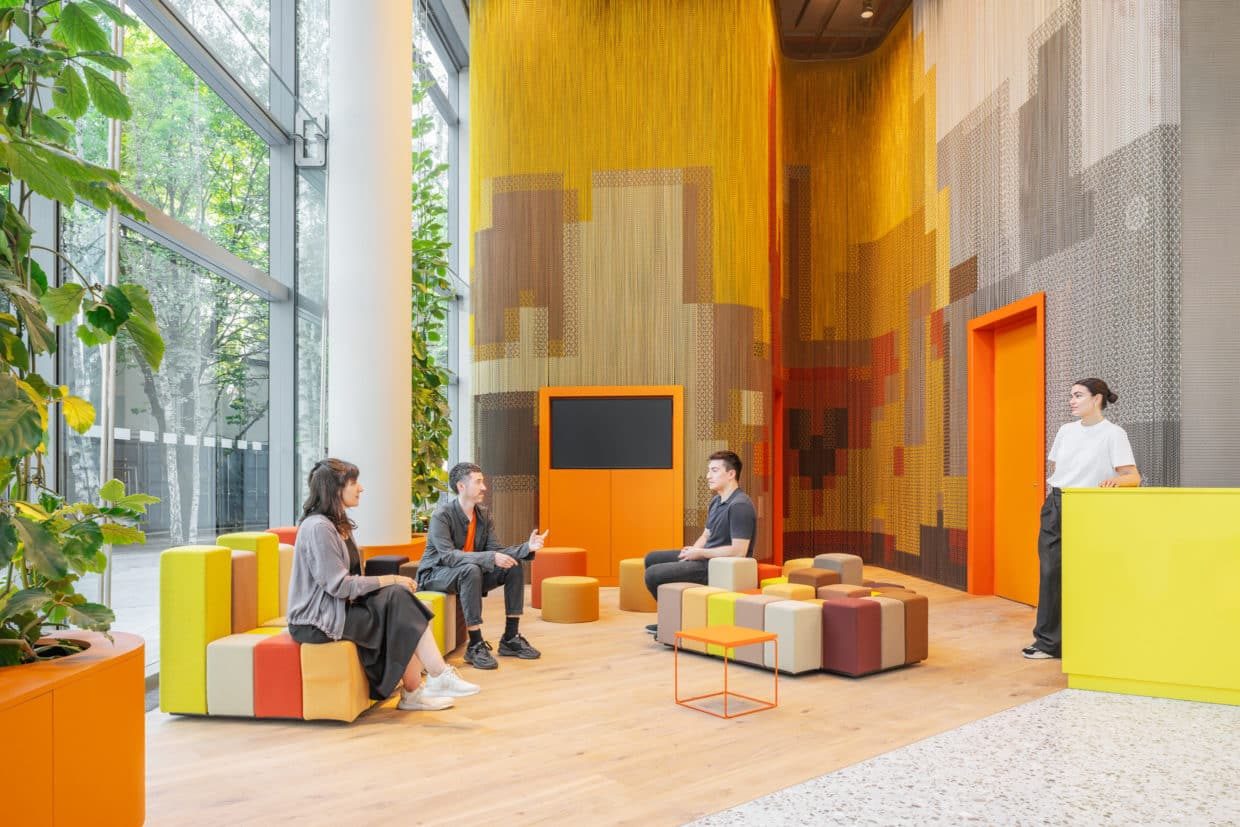 Lobby with a textured chain wall installation and modular seating