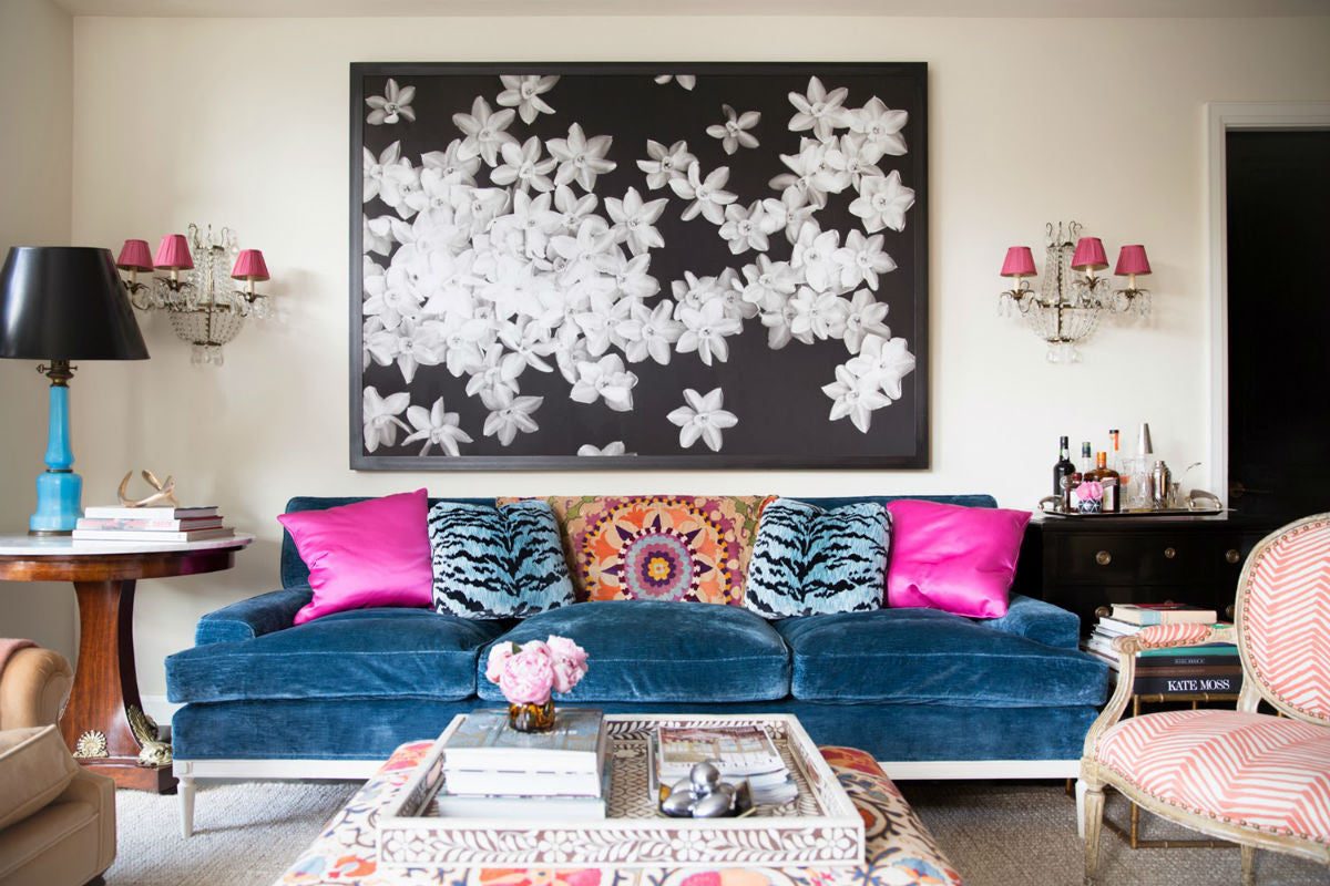 Layered upholstery, pillows, and drapery in a colorful sitting room